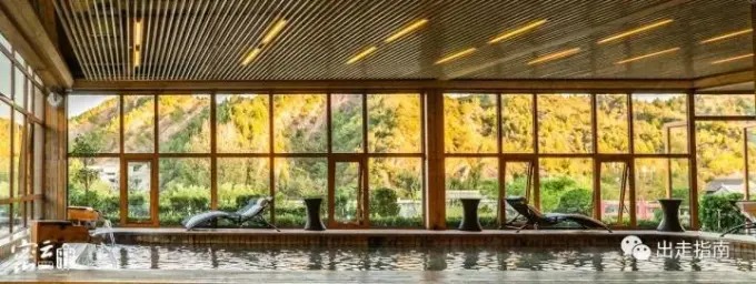 Indoor bathing pool beside large windows