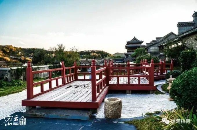Red-railed bridge beside the town’s waterside buildings